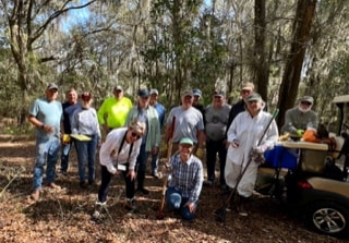 CPV volunteer group posing under Spanish moss trees at a community project site