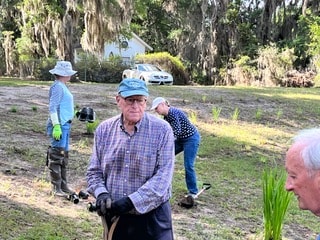 CPV volunteers planting grass seedlings along a community green space