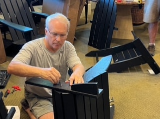 CPV volunteer assembling outdoor furniture for the community